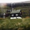 House with waterfall behind