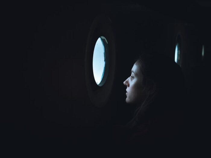 Girl looking through boat window