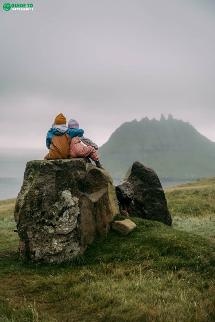 Children sitting on a stone