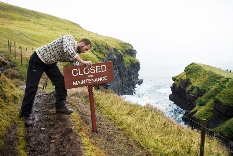 Person with wooden sign in nature