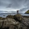 Couple standing on stone by the seaside