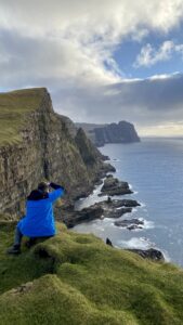 Person in blue jacket taking photo