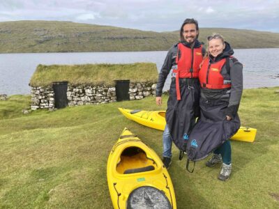Travellers next to kayak
