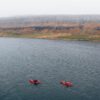 Red kayaks on lake