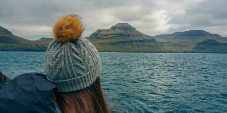Person with hat at sea