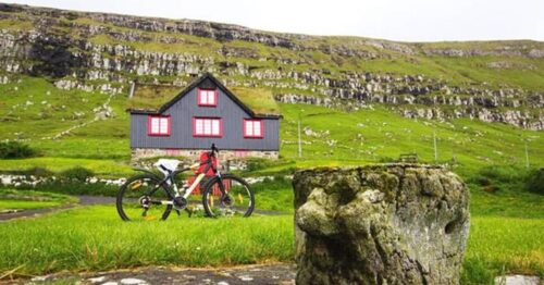 Bicycle in front of sod-roofed house
