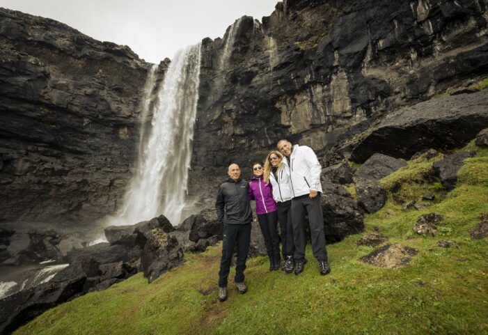 People in front of waterfall