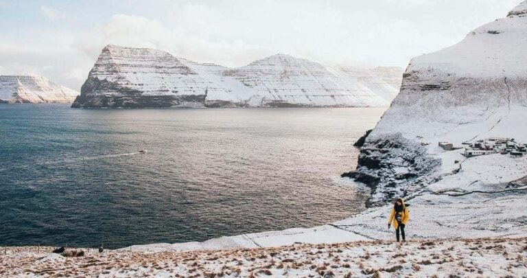 Person walking Kalsoy Island in winter