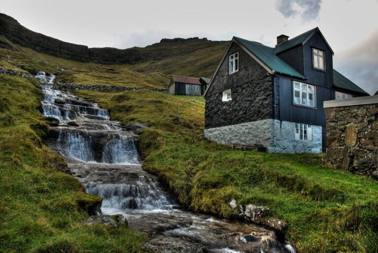 Waterfall next to black house