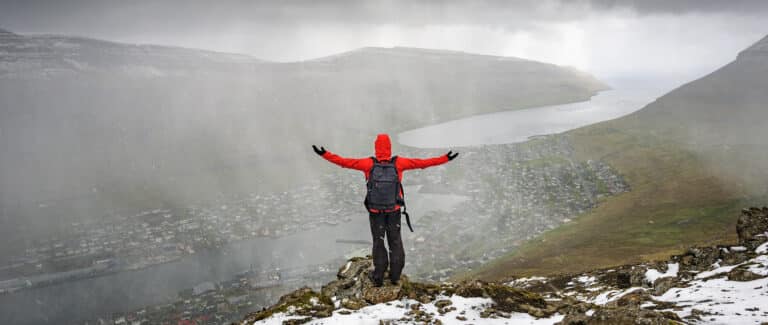 Person standing pouring rain