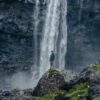 Person in front of waterfall