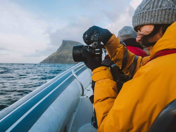 Woman taking photo in Faroe Islands