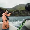 Person pointing a waterfall