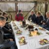 People sitting at a table in a shed