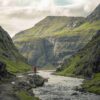 Person standing next to river
