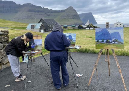 People painting in the village Viðareiði