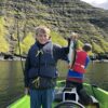 Boy holding fish and rod