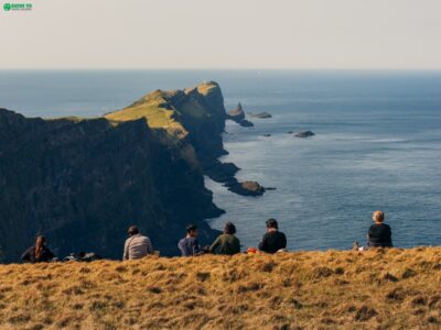 Travellers sitting on Mykines Island