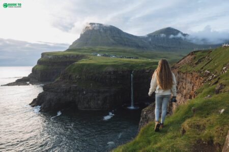 Múlafossur Waterfall with girl in frame