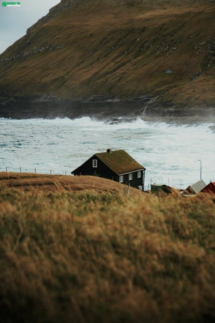 House in front of rough sea