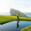 Hiker next to pond in Faroe Islands