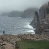 Person next to rugged coastline