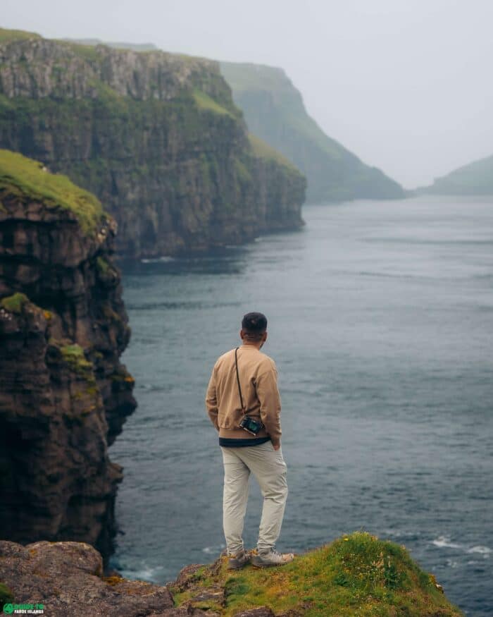 Person standing in front of cliffs