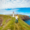 People in fornt of lighthouse